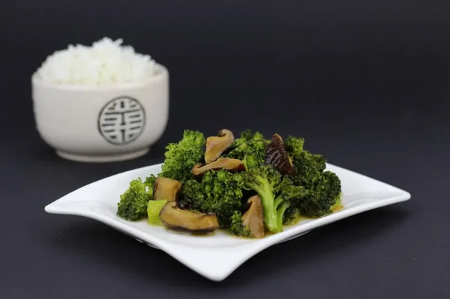 broccoli rabe substitutes-chinese broccoli on a plate next to a bowl of rice