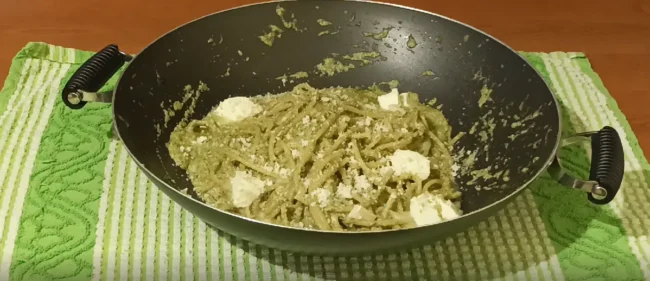 final steps of this cabbage pesto pasta recipe: adding butter and parmesan