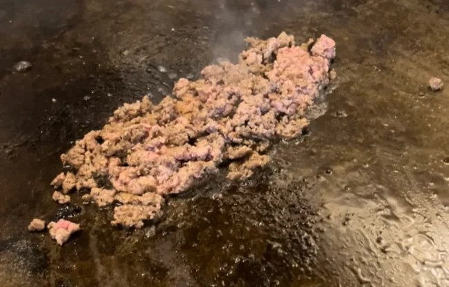 ground beef searing in frying pan