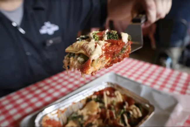 a more detailed look into the layers of pasta that are in a slice of lasagna al forno