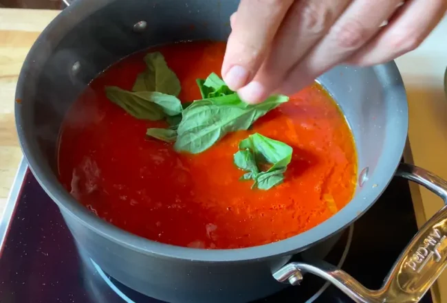 pasta sauce cooking on medium heat in a pot