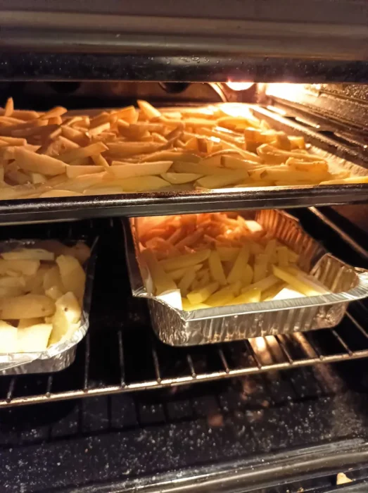 parmesan truffle fries baking in an oven