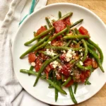 sauteed frozen green beans on a white plate