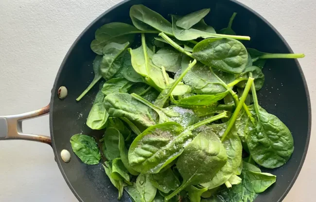 adding spinach leaves