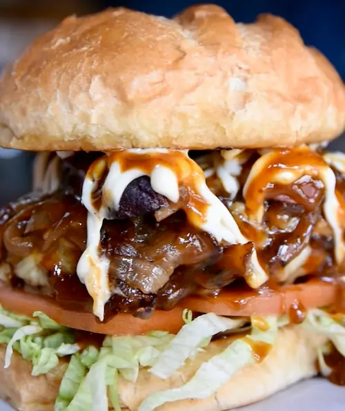 a juicy burger with sauteed mushrooms and onions