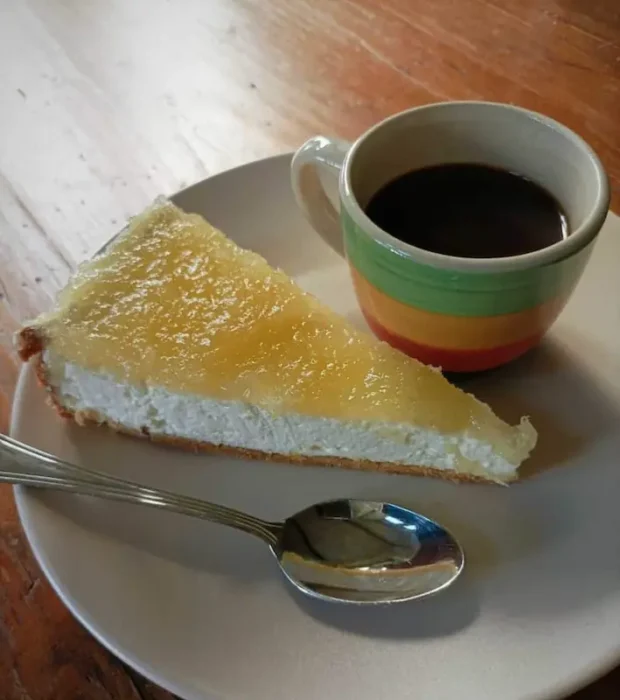 a delicious cheese pie next to a small espresso cup