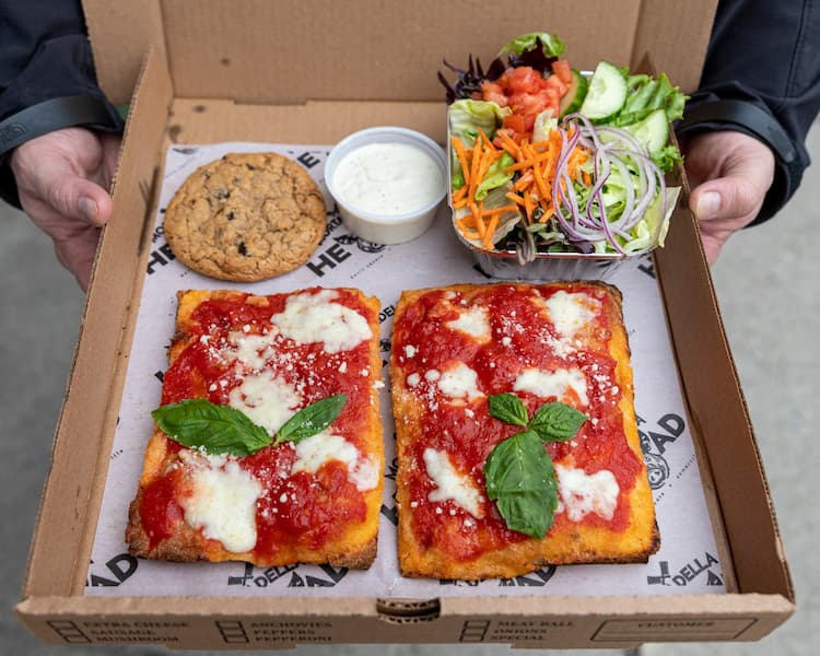 a box with pizza made with low sodium marinara, a salad, and a cookie