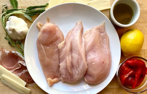 the ingredients for this chicken rollatini recipe on a wooden surface