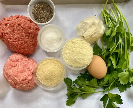 the ingredients for fried meatballs on a baking dish