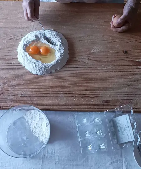 eggs and all purpose flour on a wooden surface