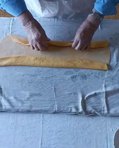 Making pappardelle pasta, cutting pasta dough into strips