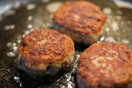 frying meatballs in a skillet