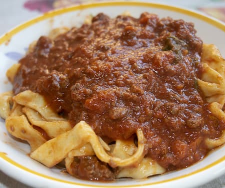 Italian pappardelle pasta dressed with a hearty wild boar ragout