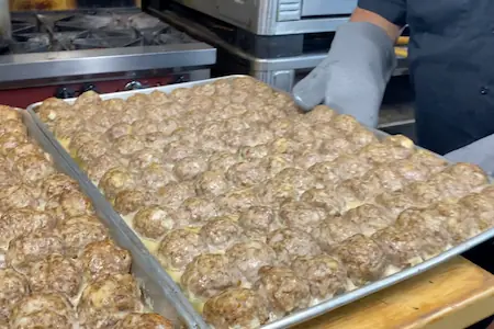 baking trays full of meatballs