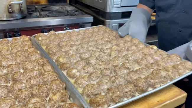 Our meatballs in bulk on a tray, cooked brown to perfection