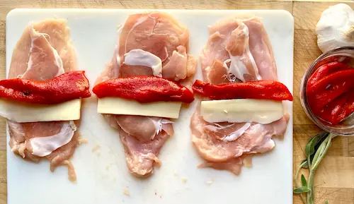 adding mozzarella and parma ham to the chicken