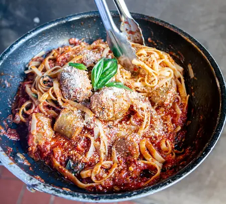 meatballs in a skillet with tomato sauce