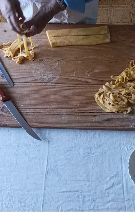 Making pappardelle pasta, cutting pasta dough into strips