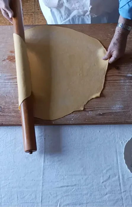 rolling out pasta dough with a rolling pin