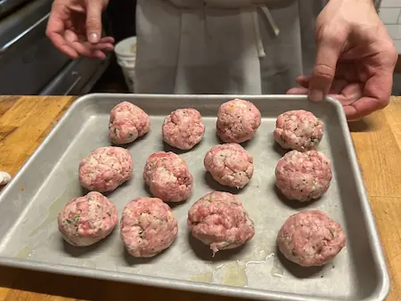 tender meatballs without eggs in an oven tray ready to be baked