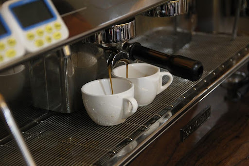 a coffee maker making two shots of espresso