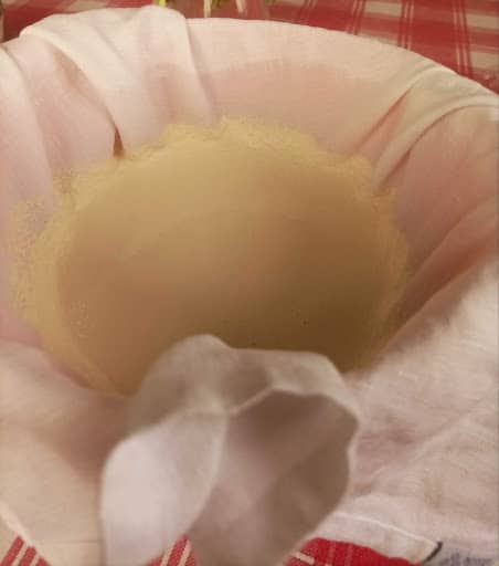 sifting soy milk with cheesecloth. 