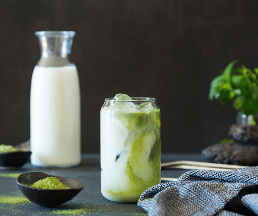 iced matcha latte with oat milk in mason jar