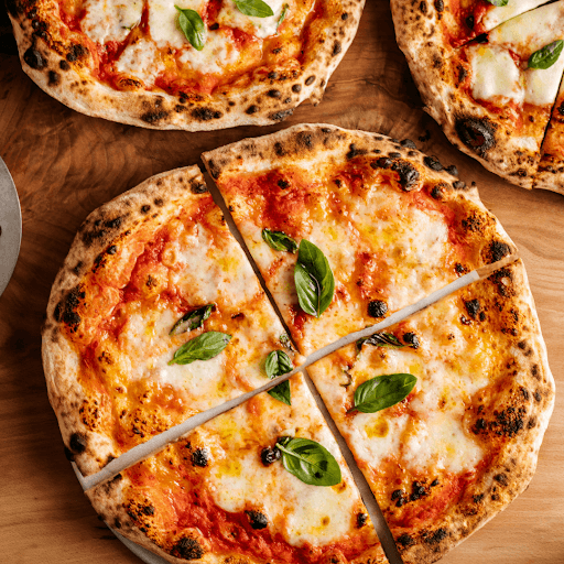 Baked pizzas showing crisp crust and melted cheese