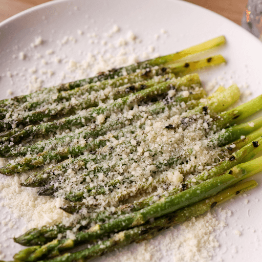Grilled asparagus topped with grated cheese