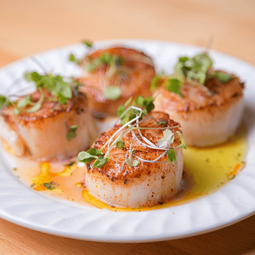 Pan seared scallops in butter sauce with fresh microgreens