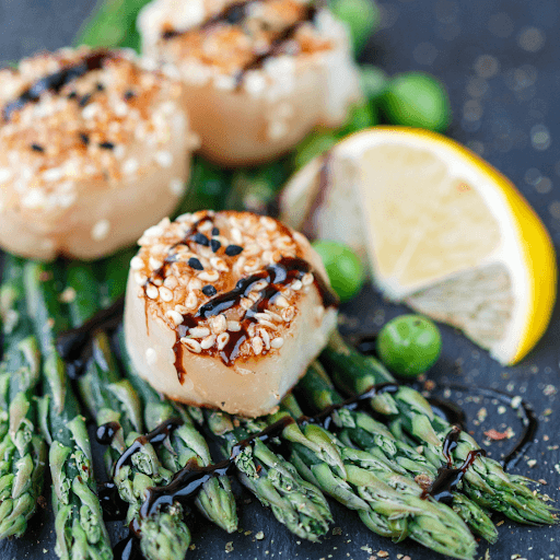 Seared scallops served over roasted asparagus